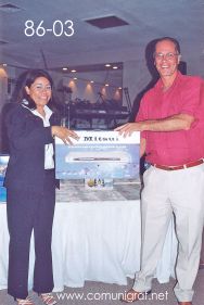 Foto 86-03 - Otro feliz afortunado con un reproductor de DVD Mitsui, lo entrega Delia Hernández (izq) en la tradicional Comida Baile del día del Impresor de Canagraf Guanajuato, realizada el 24 de Septiembre 2005 en el Hotel La Nueva Estancia de la Ciudad de León, Guanajuato México.