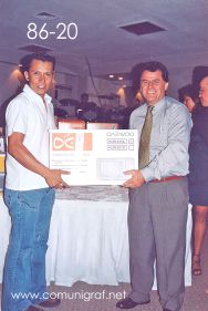 Foto 86-20 - Feliz afortunado con un horno de micro-ondas, lo entrega el Ing. Fco. Javier Navarro (der) en la tradicional Comida Baile del día del Impresor de Canagraf Guanajuato, realizada el 24 de Septiembre 2005 en el Hotel La Nueva Estancia de la Ciudad de León, Guanajuato México.